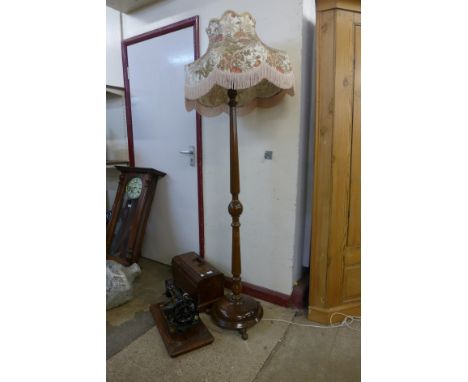 A cased Jones sewing machine and an oak standard lamp 
