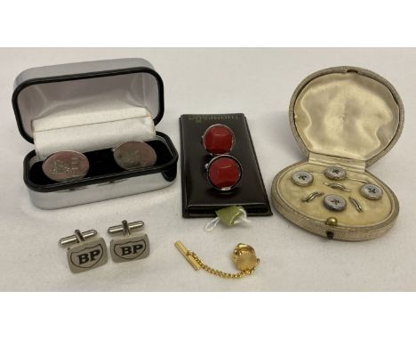 A small collection of cufflinks and tie pins. To include a vintage cased set of white metal  matching tie pin and shirt studs