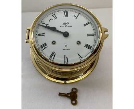 A modern brass cased mechanical ships bell clock by Schatz, complete with key. With 4 hour strike sequence.  Total diameter a