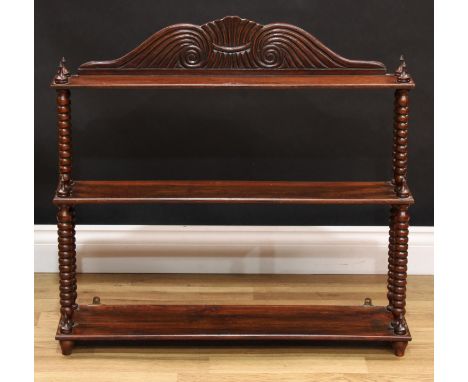 A Regency style mahogany waterfall wall shelf, reeded scroll pediment, spire finials, bobbin-turned supports, 71cm high, 76cm