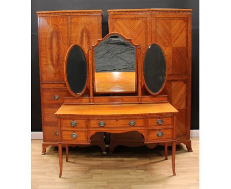 A Waring &amp; Gillow Sheraton Revival satinwood three-piece bedroom suite, comprising a dressing table, a double wadrobe and