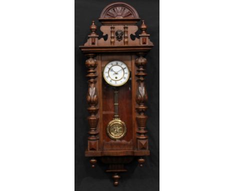 A 19th century style Vienna type wall clock, the case pediment applied with a mask, the door flanked by turned and acanthus c