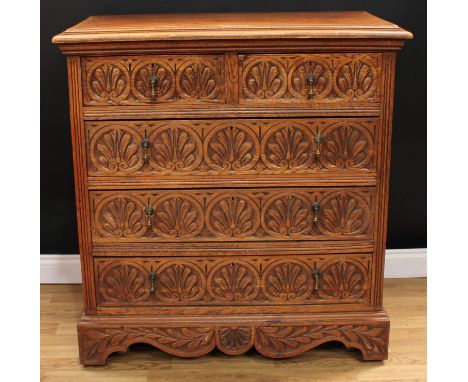 An early 20th century oak chest, moulded rectangular top above two short and three long drawers, the fronts carved with rows 