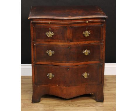 A George III Revival serpentine mahogany crossbanded walnut bachelor's chest, slightly oversailing top with moulded edge abov