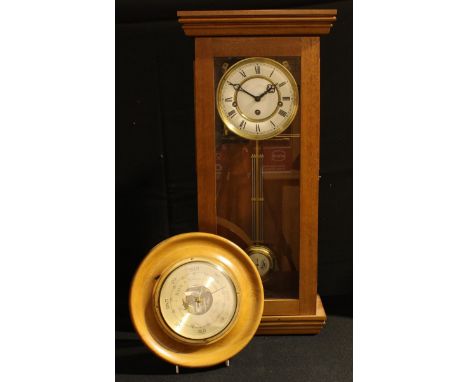 A 20th century wall clock, 8 day movement, 60.5cm high; a circular aneroid barometer (2) 