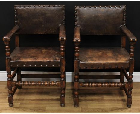 A pair of Cromwellian Revival open armchairs, in the manner of Augustus Welby Northmore Pugin, each with studded stuffed-over