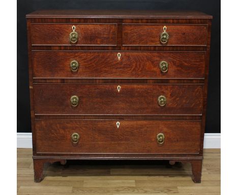 A Regency oak chest, rectangular top with reeded edge above two short and three long graduated cockbeaded drawers, brass ring