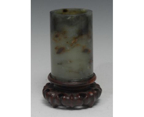 A Chinese russet jade cylinder brush pot, quite plain, the carved in relief with concentric bands, 10.5cm high, hardwood stan