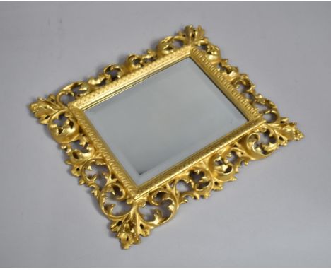 A Small Florentine Style Gilt Framed Wall Mirror with Pierced Surround. 34x41cms 