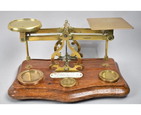 A Set of Large Brass Postage Scales, Late Victorian or Edwardian, with Weights and Oak Plinth Base. 26cms Wide.