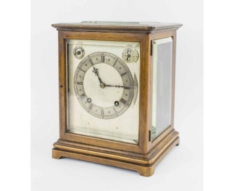 AN ANTIQUE MANTEL CLOCK, the mahogany Gorge case with bevelled glass sides and doors, 25.5cm H x 18cm D x 19.5cm W.