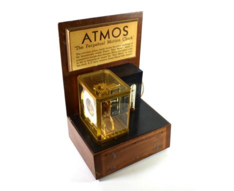 A Brass Atmos Advertising Clock, signed LeCoultre Co, 20th century, movement numbered 19317, white chapter ring with Arabic a
