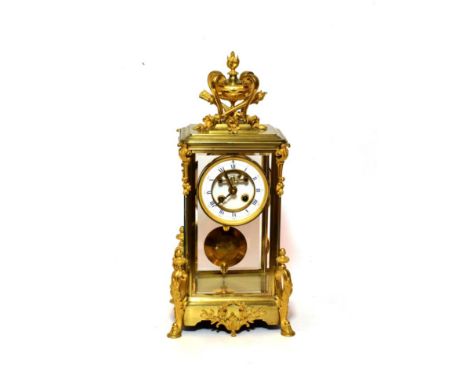 A Gilt Brass Four Glass Striking Mantel Clock, circa 1890, urn finial, scroll mounts, hoof feet, 4-inch enamel dial with Roma