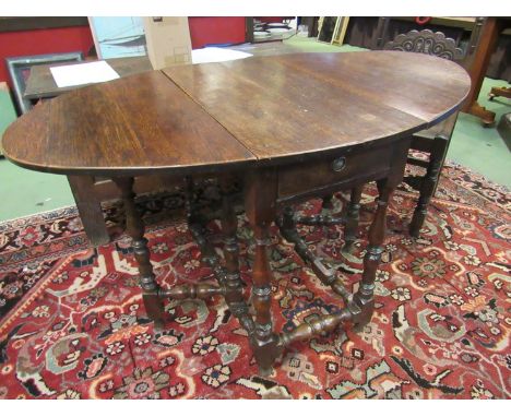 An 18th Century oak gate leg table with single frieze drawer 