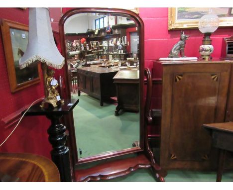 A Victorian style mahogany dome top cheval mirror with bevelled glass, on scroll supports and legs with shaped plateau shelf