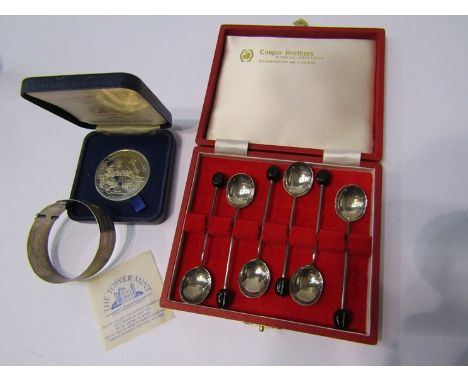 A set of six silver coffee spoons, a silver bangle and a British Legion coin 