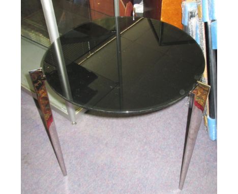 LAMP TABLE, of Art Deco influence, the circular black glass top on a base with three polished steel supports, 54cm H x 48cm. 