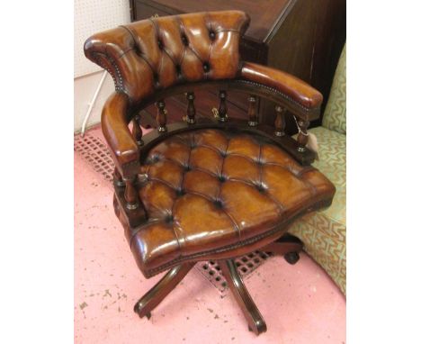 REVOLVING DESK CHAIR, tan brown leather upholstered with deep button back, arms and seat revolving and reclining on an adjust