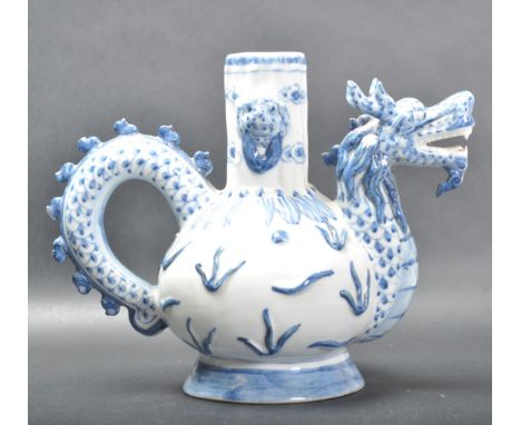 A 19th century Chinese oriental blue and white teapot. The teapot having dragon head spout and dragon tail handle raised circ