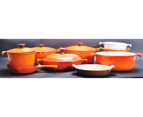 A collection of vintage late 20th century Le Creuset kitchen cooking ware comprising of lidded pots of various sizes, pans an