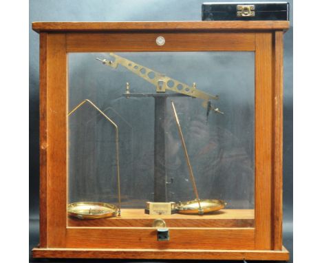 A vintage 20th century glass and oak cased balance scale retailed by Philip Harris of Birmingham. Scales comes with a set of 