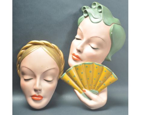A pair of Art Deco style mid 20th century circa 1950s ceramic wall plaques / face masks comprising of a ladies face together 