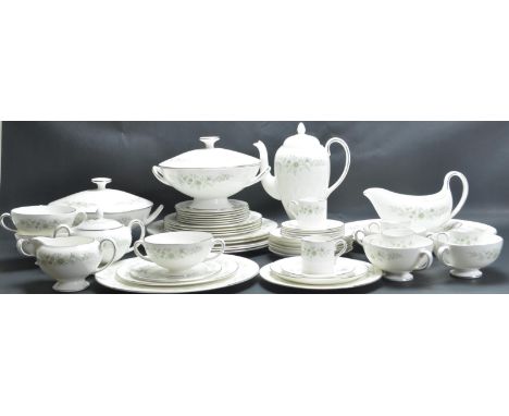 A vintage 20th century porcelain Wedgwood dinner service in the Westbury pattern having green foliate decoration. The service