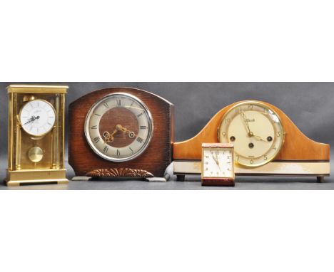 A group of four mid 20th century eight day desk top clocks / mantle clocks. The collection comprising of two mantle clocks wi