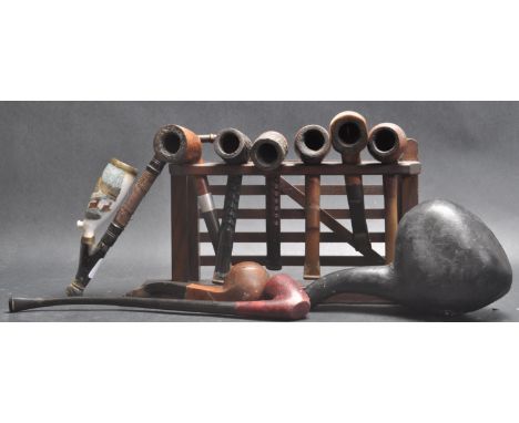 A large collection of vintage retro mid 20th century smokers pipes of various shapes and sizes. The collection includes maker