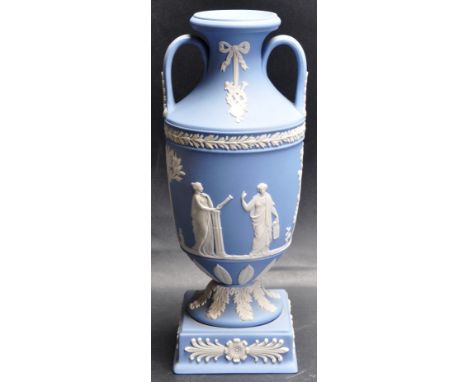 A late 20th Century Wedgwood Jasperware light blue twin handled vase having raised neoclassical decoration raised on a square