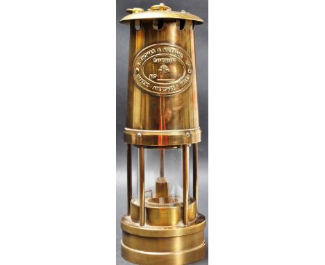 A 20th century brass miners lamp of a tYpical form by E. Thomas Williams LTd, - Aberdare - &nbsp;stamped “ Made in Wales “ 19