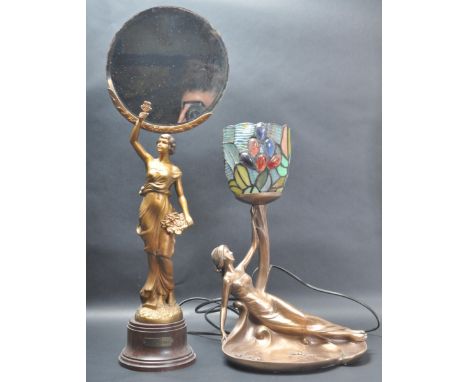 A vintage 20th century Art Nouveau style mirror having a circular mirror glass held by a woman holding flowers. Stamped Le Pr