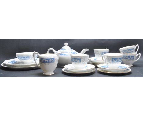 A vintage 20th century tea service by Coalport in the Revelry pattern having blue foliate decoration with putti to the side. 