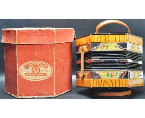 A vintage retro mid 20th century circa 1970’s German made concertina / squeeze box musical instrument of a hexagonal form wit