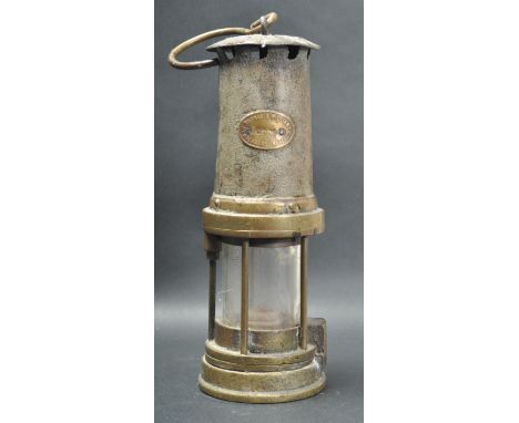 An early 20th century Thomas A Williams Aberdare Welsh miners mining lamp having a hook to the top over a cylindrical glass s