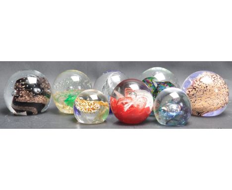 A collection of eight retro vintage studio art glass paperweights by Caithness. The paperweights include bubble control, heli
