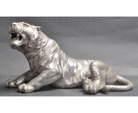 A vintage retro 20th century circa 1980’s silver plated Indian tiger cabinet figurine. The tiger posing in sitting position w