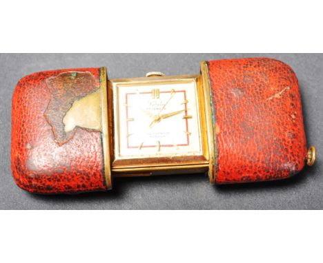 A vintage retro mid 20th century traveling clock / watch by Verity. The watch having a champagne dial, button numerals to the