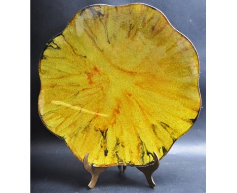 A retro vintage mid 20th century circa 1960s Murano style glass charger having scalloped edges in an amber and black colourwa