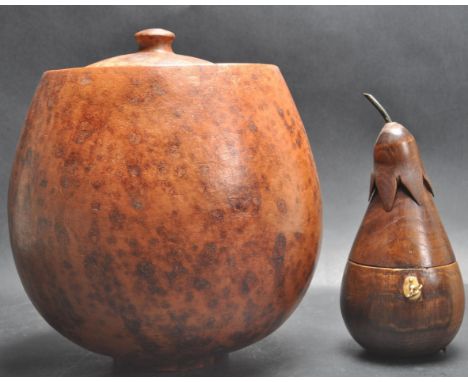A Georgian III style fruitwood tea caddy in the form of a pear with an armorial shaped escutcheon to the front with key and h