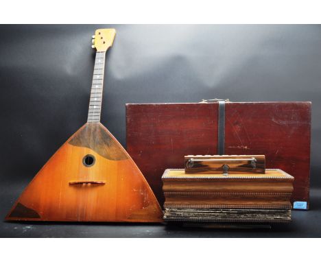 A collection of three vintage mid 20th century musical instruments comprising of a Balalaika,&nbsp; a cased autoharp together