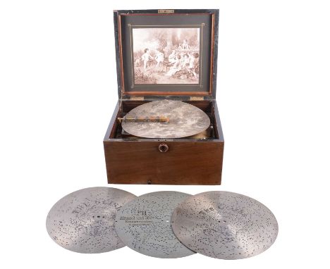 Walnut cased polyphon, playing 29cm discs, case interior with printed inset, case width 34cm; and a collection of discs.Condi