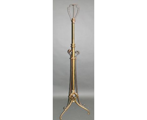 A brass and copper standard lamp in the manner of W A S Benson, with adjustable column and triform base, H. 102cm.