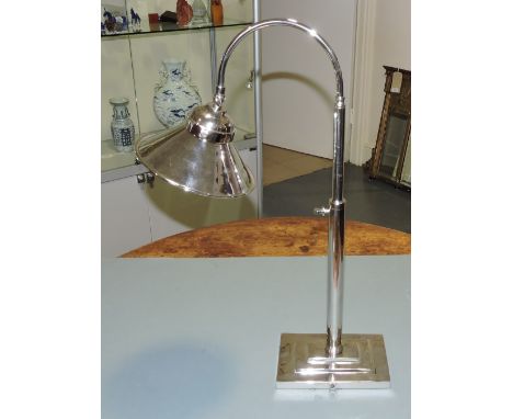 An Art Deco style plated adjustable table lamp with conical shade on stepped rectangular base.