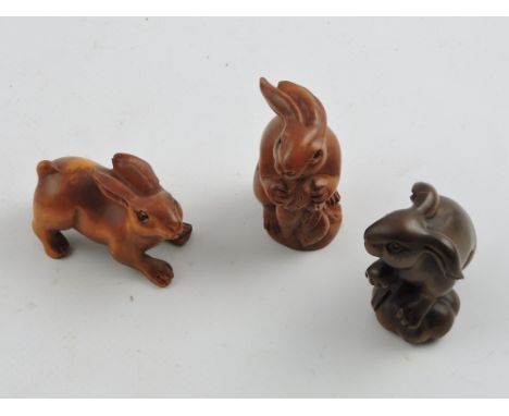 Three Chinese hardwood netsuke modelled as hares.