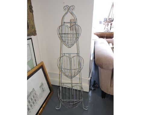A three tier jardiniere, of graduated heart shaped baskets on an easel stand, H. 137cm.
