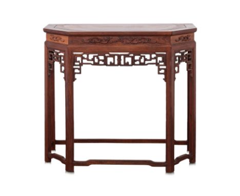 A CHINESE CARVED HARDWOOD CONSOLE TABLE
Rectangular with canted corners, carved with stylised dragons, and with openwork arch