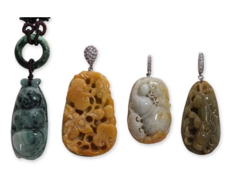 A GROUP OF FOUR BURMESE JADEITE PENDANTS
Comprising an orange-russet lingzhi and koi fish carving on silver and clear stone m