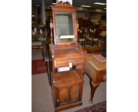 A late 19th Century gentleman's shaving stand with rectangular swing bevelled mirror on turned supports, the top tier fitted 