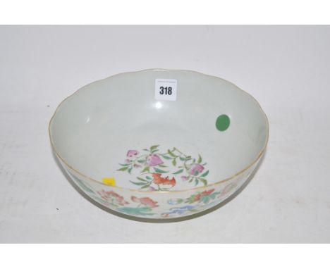 Chinese ceramic bowl decorated flowers, shrubs and butterflies on white ground.